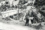 Perpectiva del acueducto en construcción y dos hombres en primer término